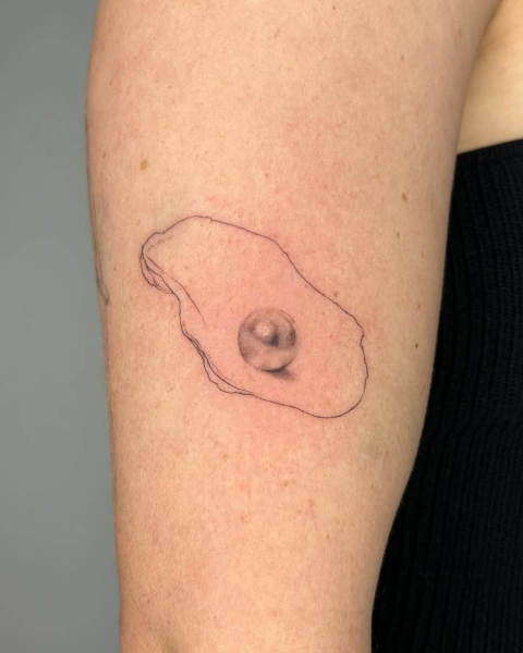oyster tattoo on upper arm